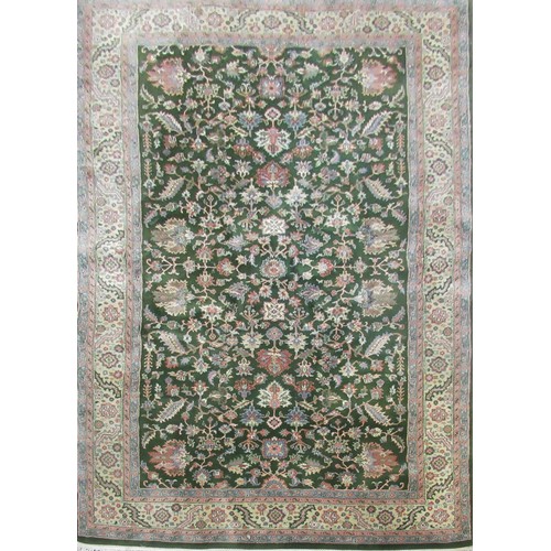 1388 - Herez pattern rug, central green ground field set with sylised floral motifs surrounded by beige flo... 