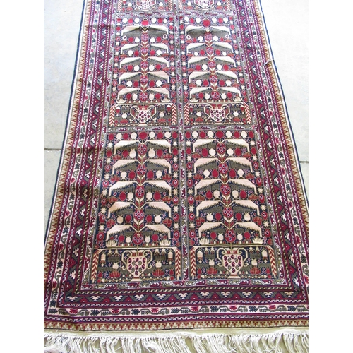 1385 - Afghan multicoloured wool runner, field with stylised geometric medallions and urns in a multi strip... 