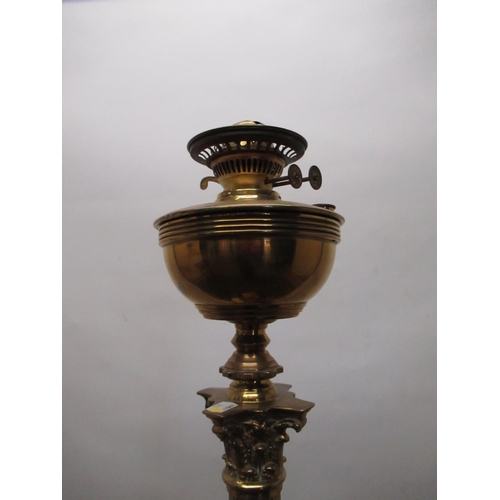 1230 - Early C20th brass floor standing oil lamp, adjustable Corinthian column on square base with four cla... 