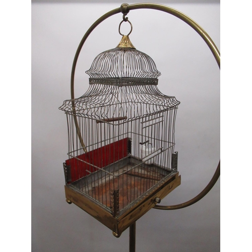 C20th brass and wirework stepped rectangular bird cage, with slide out  base, opaque glass feeder and