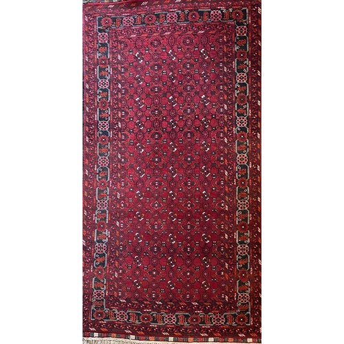 1390 - Herez pattern red ground wool rug with central field with geometric motifs, stylised striped border,... 