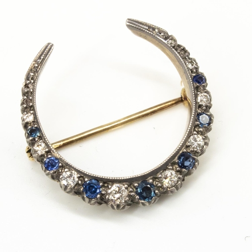1129 - Diamond and sapphire crescent brooch, seven graduated round cut sapphires separated by eight graduat... 