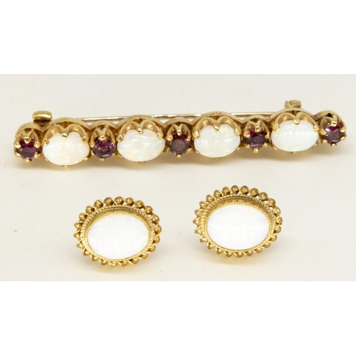 1134 - Hallmarked 9ct yellow gold opal and ruby bar brooch, four oval, claw set cabochon opals separated by... 