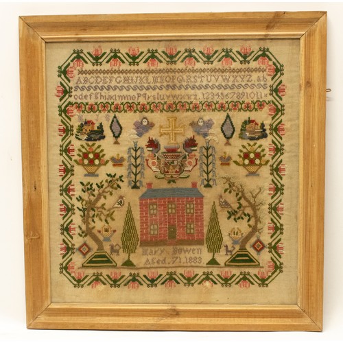 1378 - Victorian woolwork sampler worked with alphabet above house and gardens with cherubs flanking cross,... 