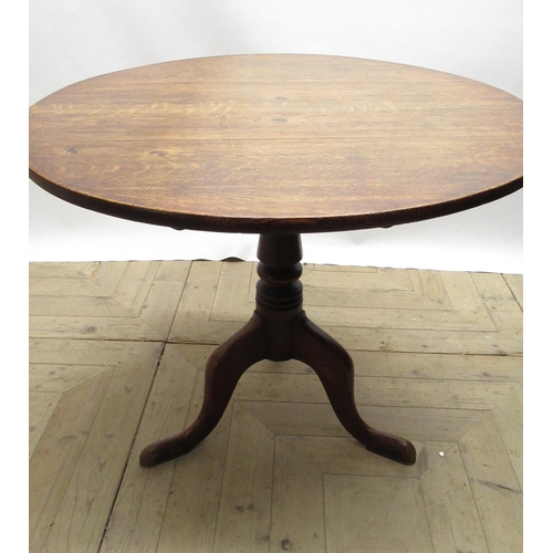 1476 - Geo.III oak tripod tea table, circular tilt top on vase turned column support and three outsplayed c... 