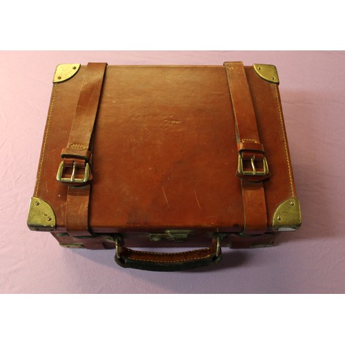 1055 - Tan leather cartridge box with brass reinforced corners, with lined and fitted four sectional interi... 