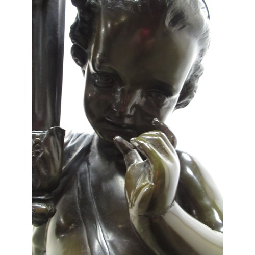1210 - After Moreau; a large patinated hollow bronze floor lamp modelled as a cherub supporting a flaming t... 