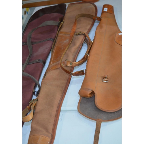 293 - Sterling maroon canvas gun carry case, a light brown canvas carry case and brown leather carry case ... 