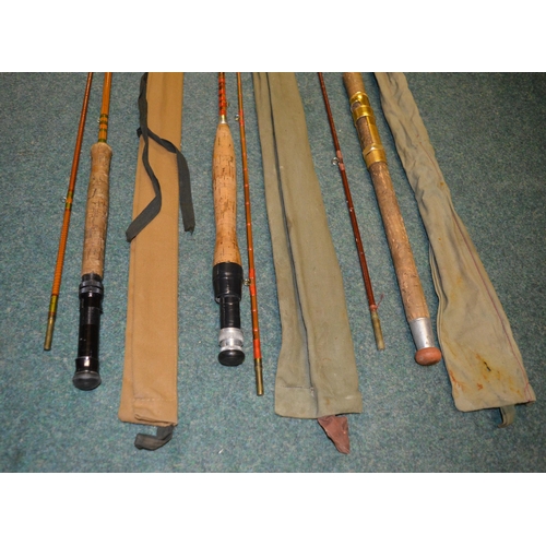 112 - Three vintage fishing rods:
An early carbon fibre two piece fishing rod L214cm, also 