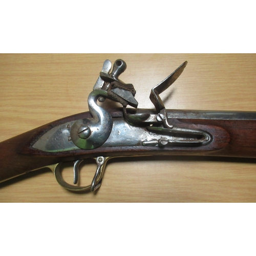 310 - Black powder 12B flintlock carbine, with brass mounts, 25