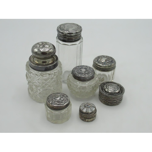 101 - Collection of hallmarked sterling silver topped dressing table jars and two white metal lidded jars,... 