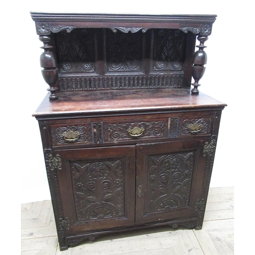 556 - C18th and later oak court type cupboard, back carved with stylised foliage and lunettes, W108cm D51c... 