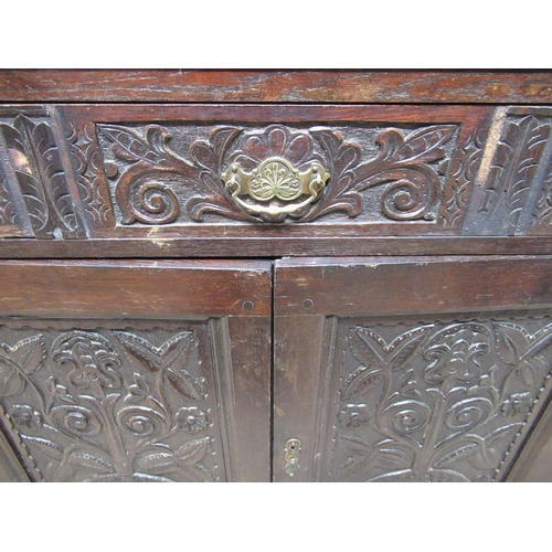 556 - C18th and later oak court type cupboard, back carved with stylised foliage and lunettes, W108cm D51c... 