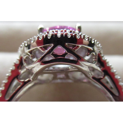 63 - 14ct white gold pink sapphire and diamond halo style ring