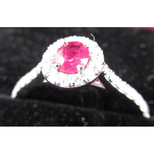 63 - 14ct white gold pink sapphire and diamond halo style ring