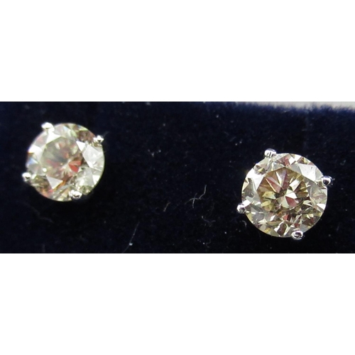 67 - Pair of white gold diamond stud earrings,  approx. 1.16ct