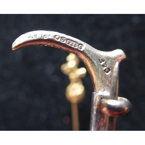 38 - Hallmarked 9ct yellow gold riding crop brooch, approx 5cm, 3.7g and a yellow metal pin stick with ho... 