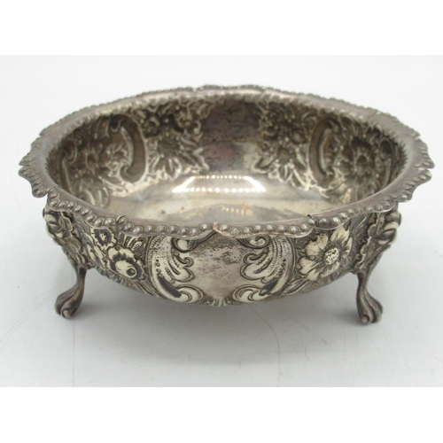 87 - Hallmarked sterling silver dish, shaped rim, repousse with scrolls and flowers, three lion mask legs... 