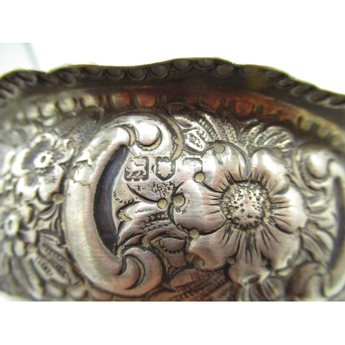 87 - Hallmarked sterling silver dish, shaped rim, repousse with scrolls and flowers, three lion mask legs... 