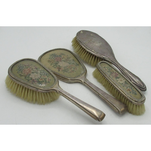 88 - Geo.V hallmarked sterling silver mounted dressing table set comprising hand mirror, clothes brush an... 