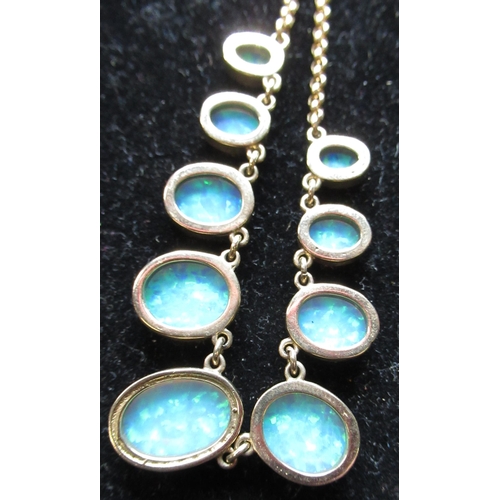 1 - 9ct yellow gold and opal necklace, nine graduated oval opal beads inset in linked 9ct yellow gold mo... 