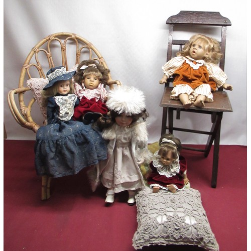 1220 - Five dolls including two porcelain with one wicker dolls/child's chair (6)