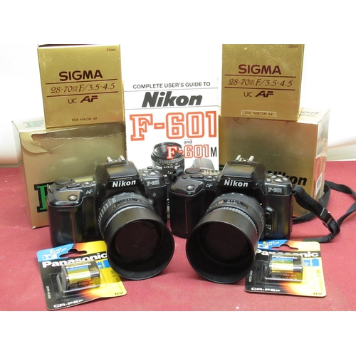 1194 - Two Nikon F-601 camera bodies, both with Sigma 28-70mm autofocus lenses, including boxes and instruc... 