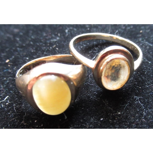 11 - Hallmarked 9ct yellow gold signet ring with a cabochon smoky hardstone, size F and a hallmarked 9ct ... 