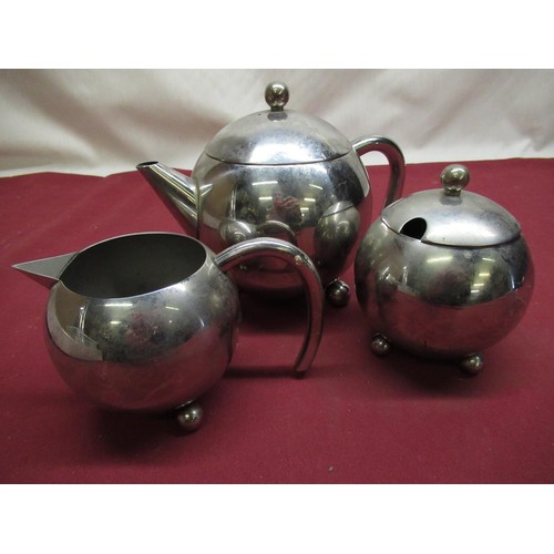 433 - 1960's stainless steel spherical three piece tea set comprising teapot, milk jug and sugar bowl, col... 