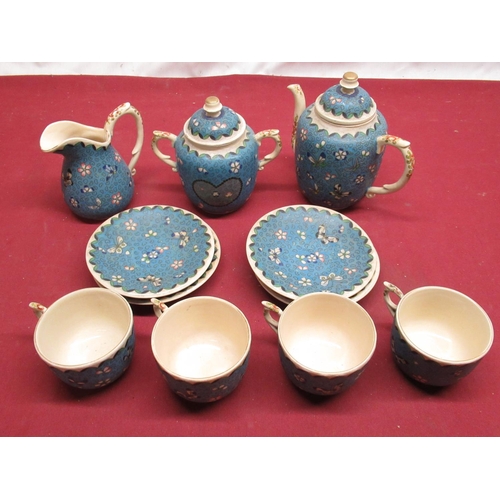 453 - Cloisonne on porcelain four person tea service decorated with foliage and butterflies on a blue grou... 