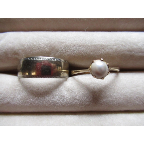 63 - Hallmarked 9ct white gold wedding band size M, and a 9ct yellow gold ring set with a simulated pearl... 