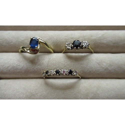 42 - Hallmarked 9ct yellow gold diamond and sapphire ring, round cut claw set sapphire flanked by two ill... 