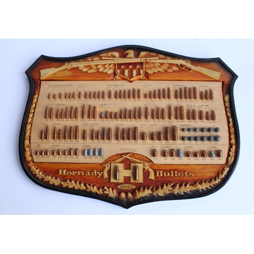 238 - Carved American plaque for Hornady bullets framing a collection of various calibre shells