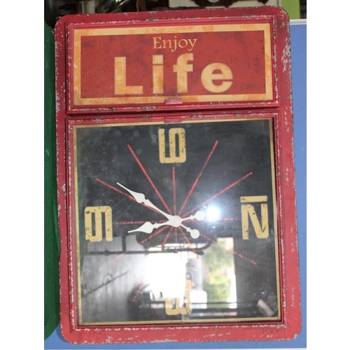 757 - Large red enamel wall clock scripted to side cupboard 'Enjoy Life', W100cm, H70cm