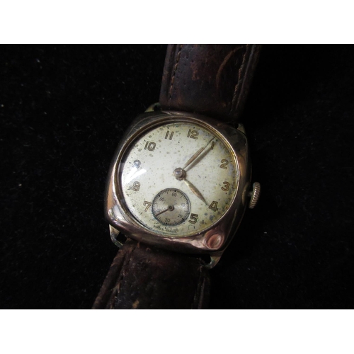 464 - Swiss, 9ct gold cased hand wound wristwatch, silvered dial painted Arabic numerals, rail track minut... 