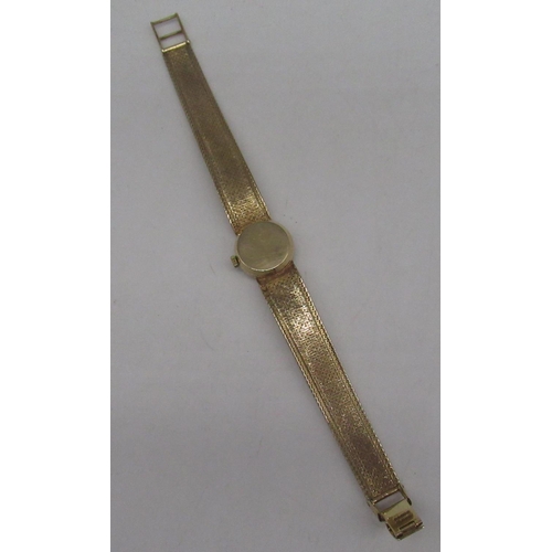 1064 - Ladies Omega 9ct gold hand wound wristwatch, signed brushed gold dial with applied baton markers, tw... 