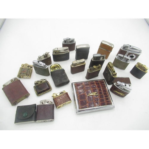 764 - Collection of early 20th century lighters, with leather covering to the majority (21)