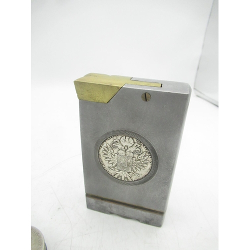 771 - Large metal lighter with Maria Theresa coin encased and a circular Maria Theresa coin lighter (2)