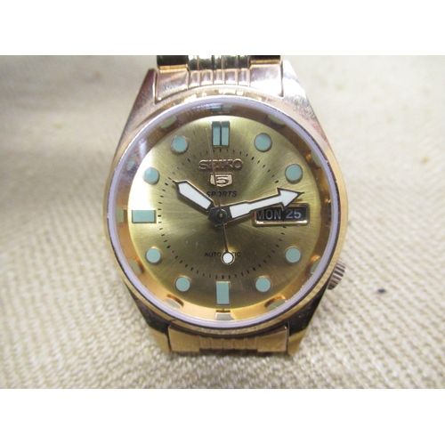 692 - Seiko 5 Sports automatic wristwatch with day date, gold plated case on matching gold plated bracelet... 