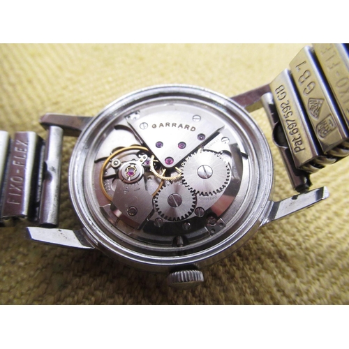 696 - Garrard hand wound wristwatch, signed silvered dial with Arabic numerals and centre seconds, stainle... 