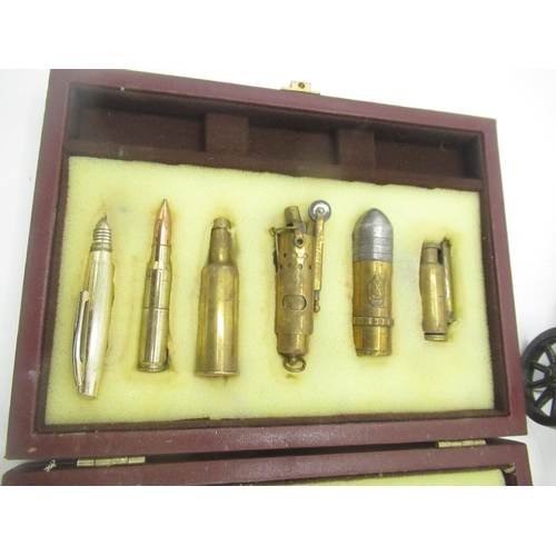 705 - Cased set of 13 Trench Art lighters, American table lighter designed as an Artillery piece and 2 Bul... 