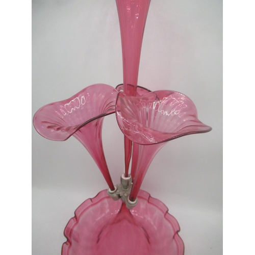 1120 - Victorian style cranberry glass epergne with four flutes on a scalloped edged circular base, H53cm