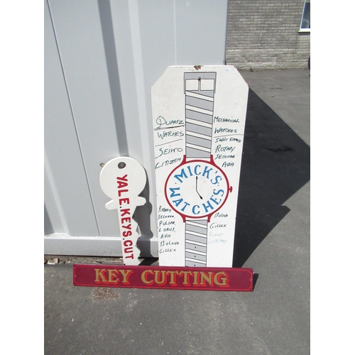 938 - Red advertising sign for watch repair and key cutting, hand painted, 183cm by 45cm, with 2 key cutti... 