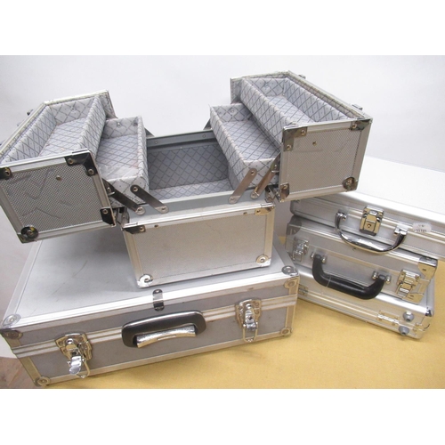 824 - Aluminum flight style cantilever jewellery box, large aluminum flight case, four similar smaller cas... 