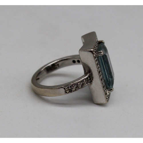 1010 - 9ct white gold ring set with emerald cut aquamarine, surrounded by diamonds in millegrain setting, s... 