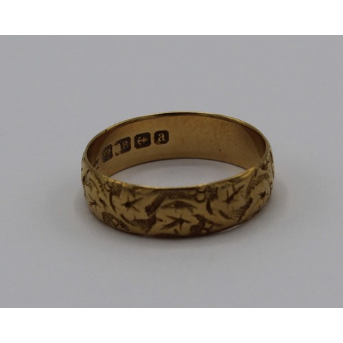 1031 - 18ct yellow gold wedding band with foliage engraved design, stamped 18ct, size U, 4.7g