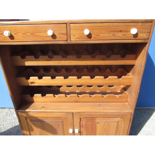 1302 - Waxed pine kitchen cabinet, arched tiled back above two drawers, 24 bottle wine rack and two doors o... 