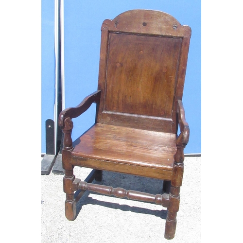 1300 - C18th and later oak Wainscot type chair, arched panelled back and solid seat with shaped arms on tur... 