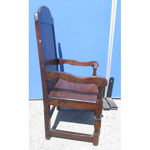 1300 - C18th and later oak Wainscot type chair, arched panelled back and solid seat with shaped arms on tur... 