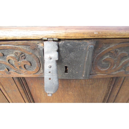 1301 - C18th oak coffer, hinged top with moulded edge, three panel front with scroll carved frieze, W120cm ... 